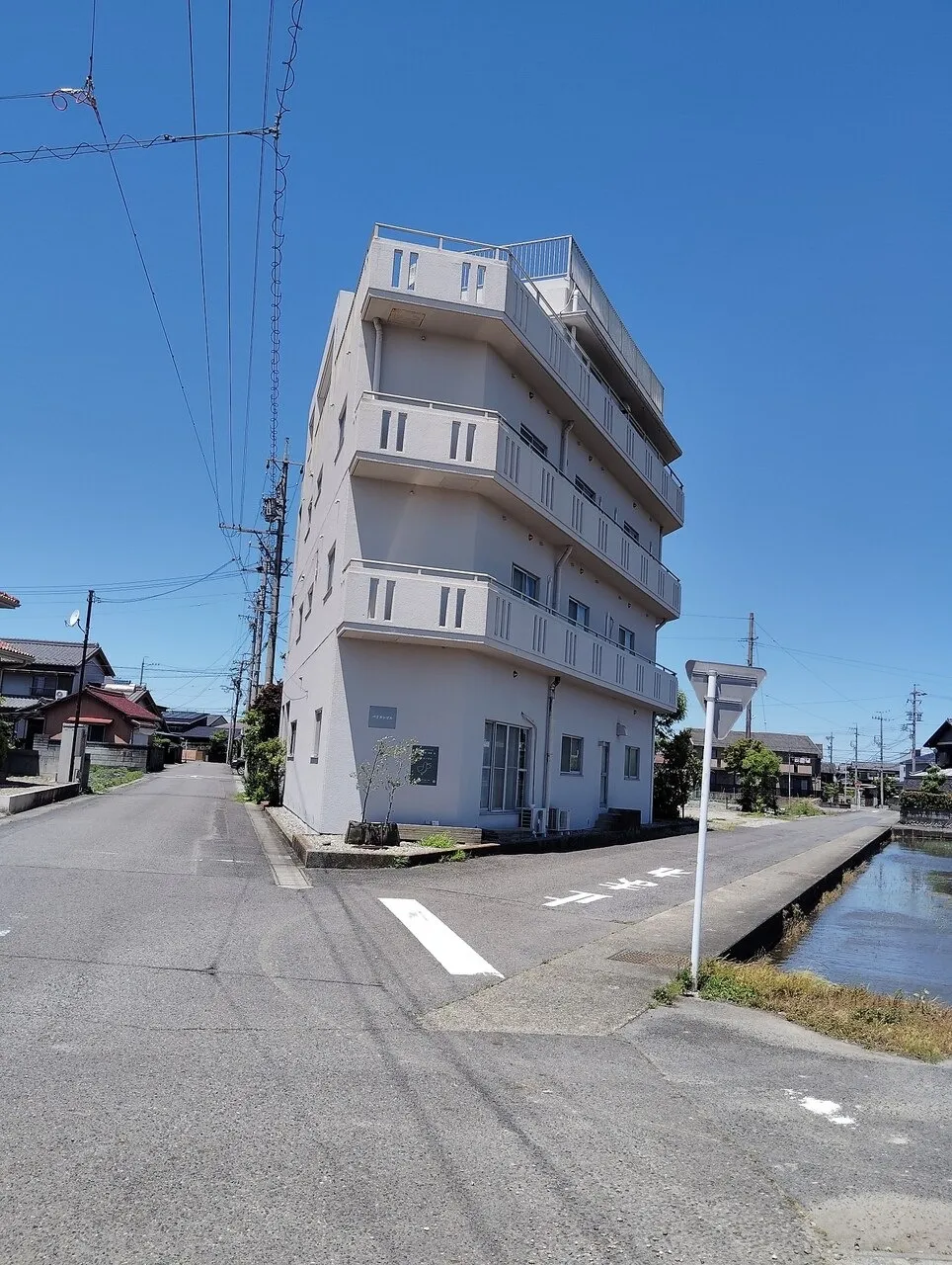 白いビルの2階2C室が当店です。